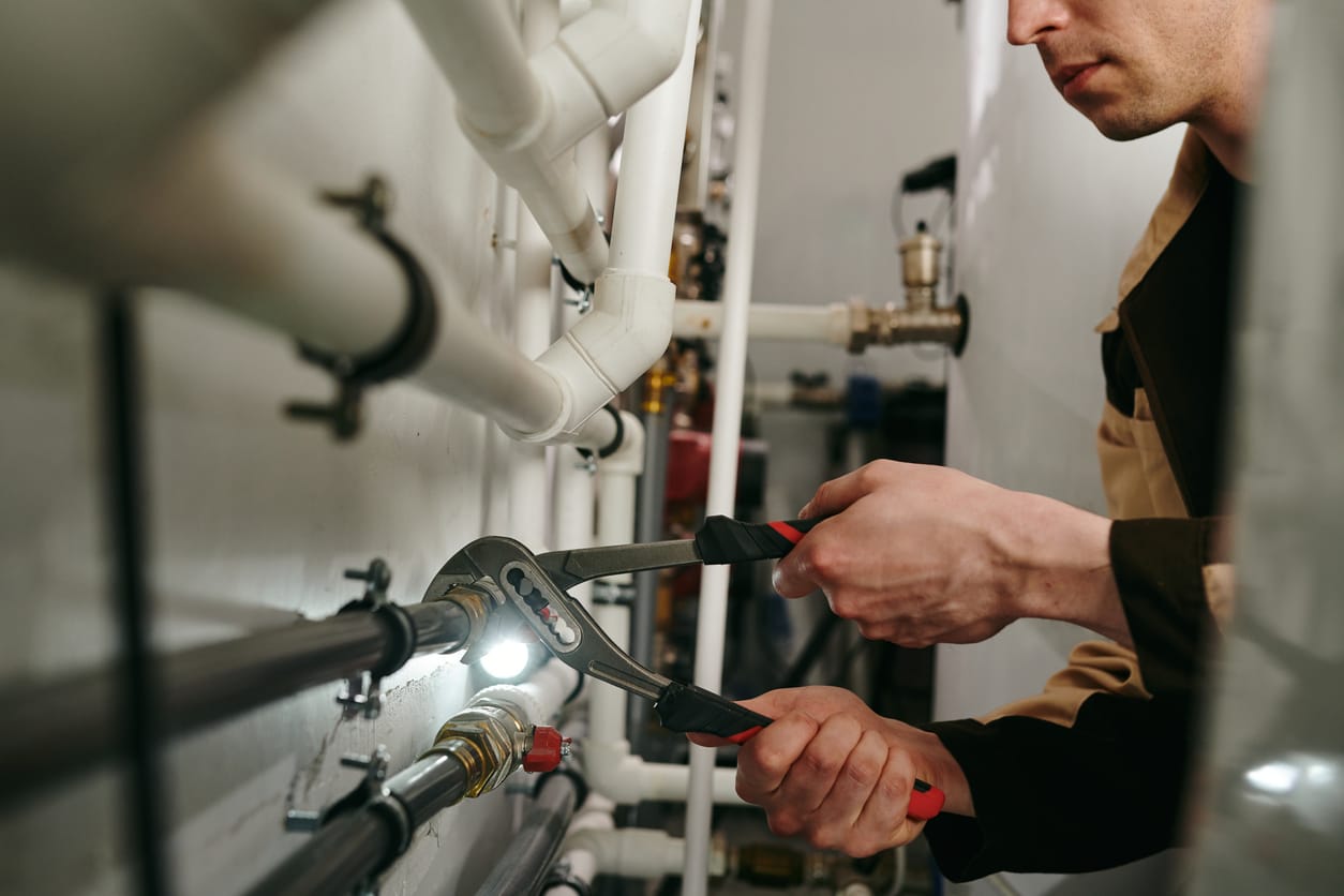 Plumbers maintaining commercial plumbing pipes in Fayetteville