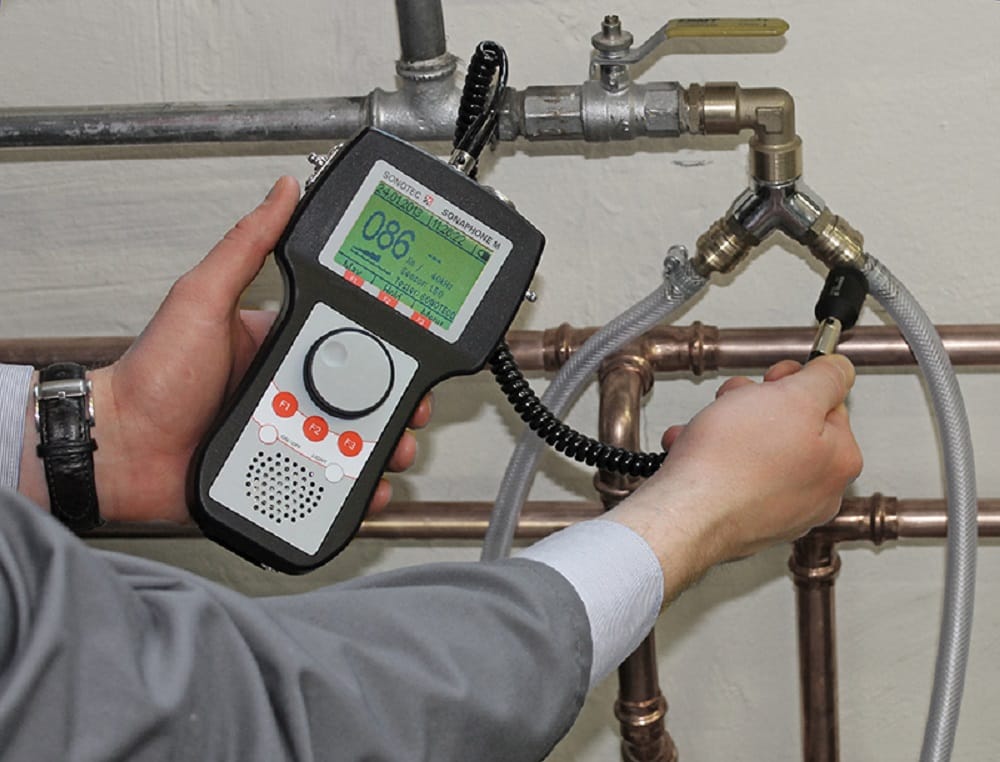 Plumber testing pipes with electronic leak detection equipment in Fayetteville