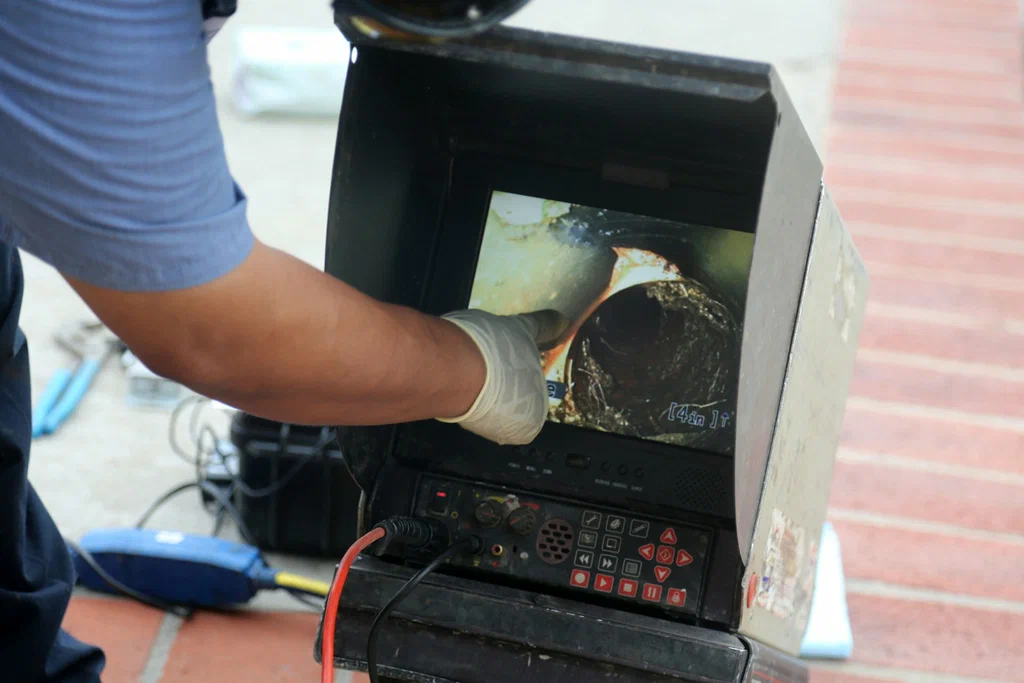 Technician viewing a drain inspection camera in Fayetteville