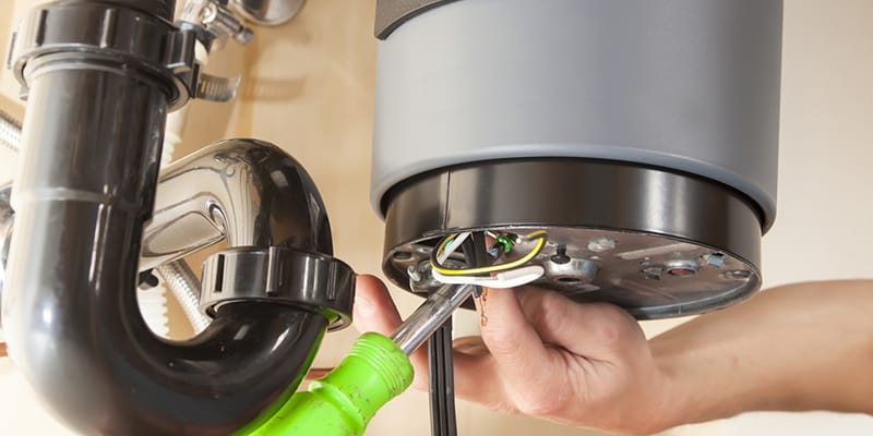 Technician repairing the heating element of a water heater in Fayetteville