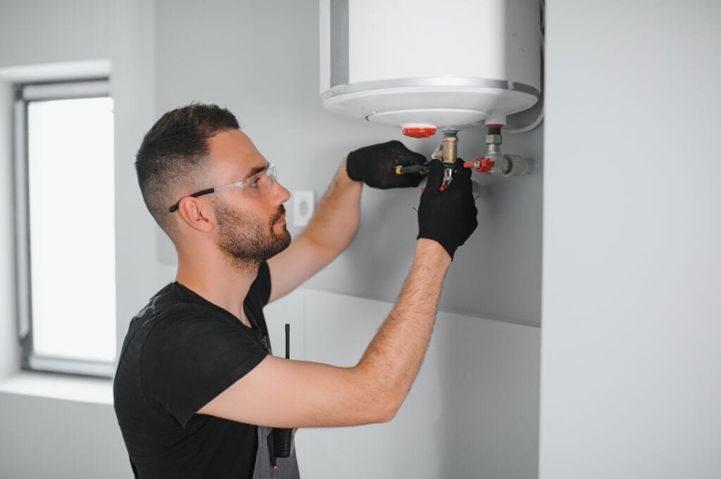 Technician performing water heater maintenance in Fayetteville