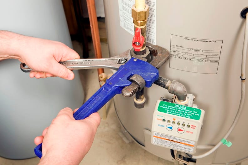 Plumber repairing a water heater valve in Fayetteville